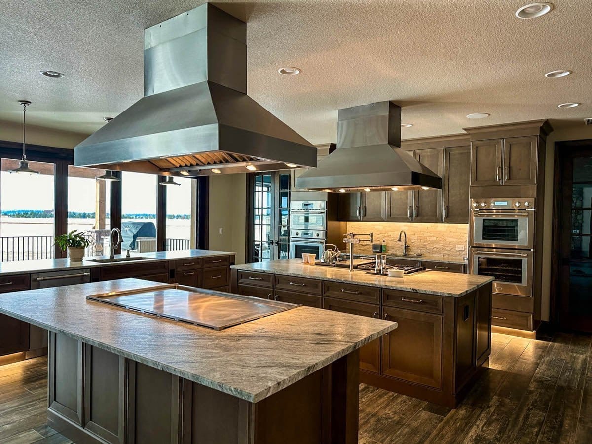Contemporary kitchen with wooden cabinets, ProlineRangeHoods.com ProVI stainless island hoods for optimal airflow and water views.