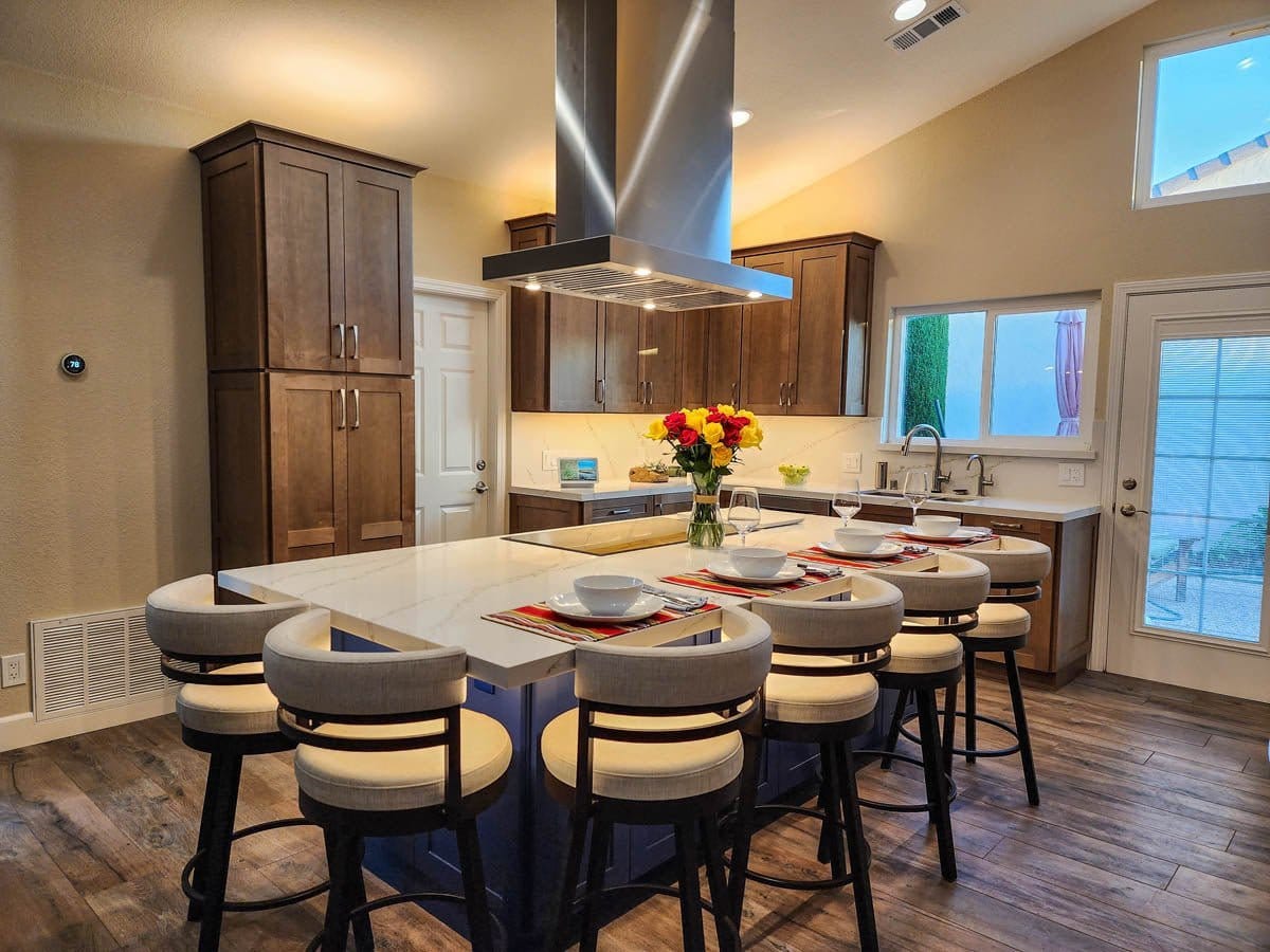Modern kitchen with island, barstools, wood cabinets, Proline PLFI 750 Range Hood. ProlineRangeHoods.com on display.