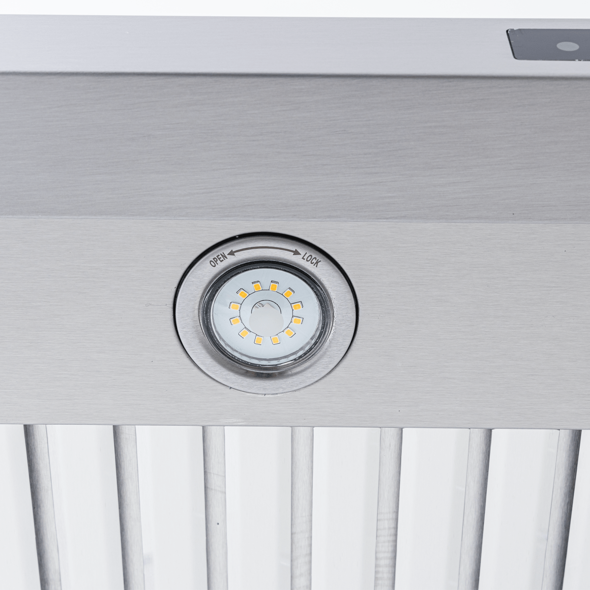 Close-up of LED light with lock/unlock indicator on Proline PLFW 129 E range hood, 900 CFM, stainless steel. ProlineRangeHoods.com.